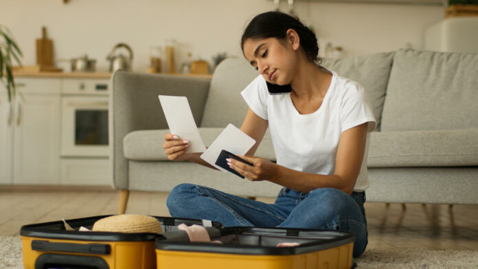 Brown woman planning a trip with passport in hand